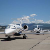 Private jets parked along side each other on the tarmac